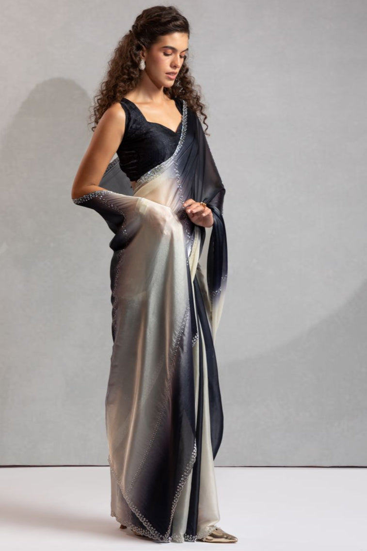 Woman wearing a long, elegant dress with a gradient effect against a neutral background