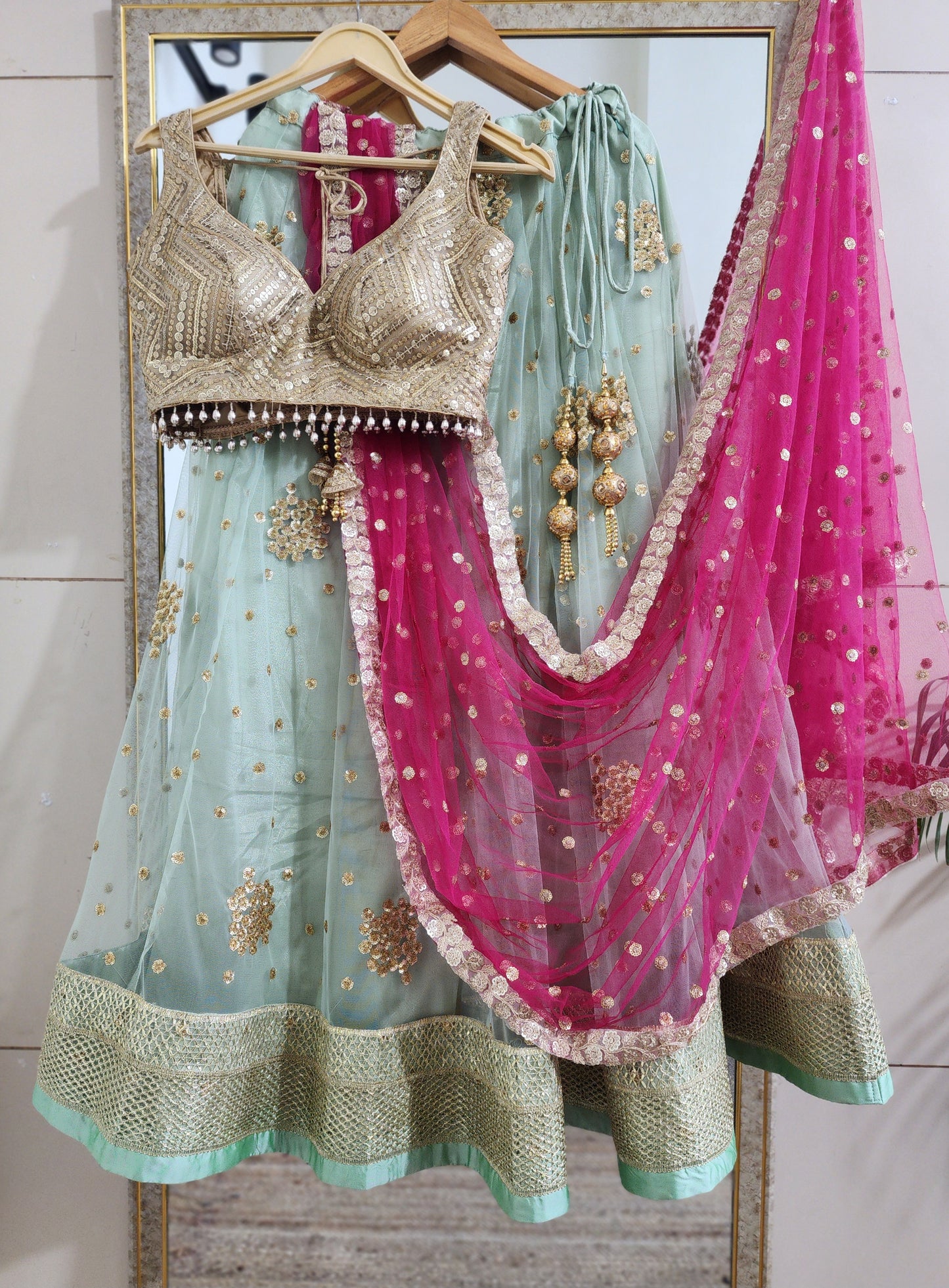 Pastel green lehenga choli with vibrant pink dupatta