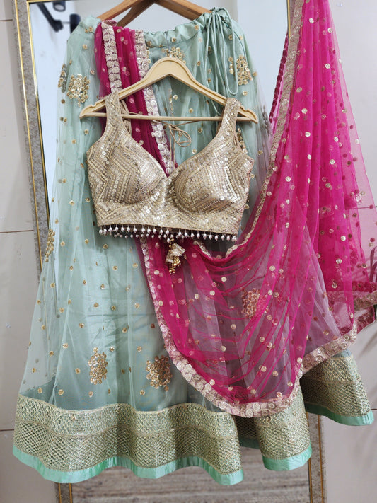 Pastel green lehenga choli with vibrant pink dupatta