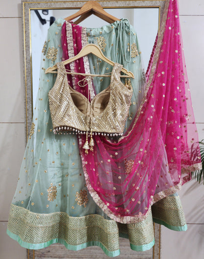 Pastel green lehenga choli with vibrant pink dupatta