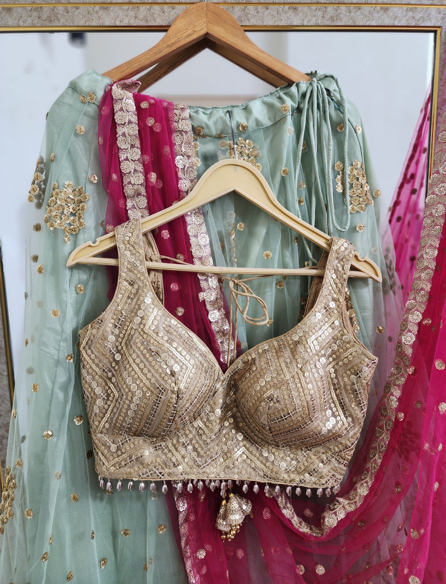 Pastel green lehenga choli with vibrant pink dupatta