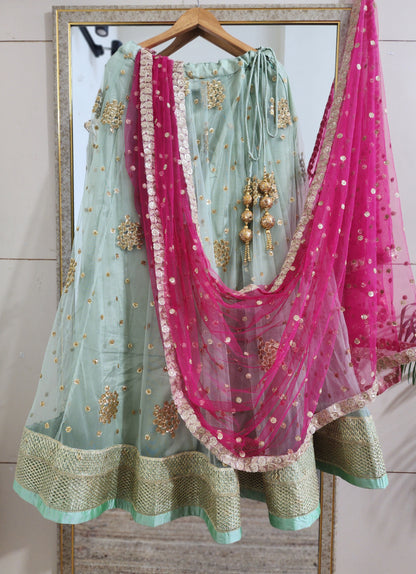 Pastel green lehenga choli with vibrant pink dupatta