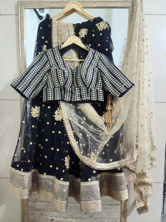 Embroidered black lehenga with golden dupatta