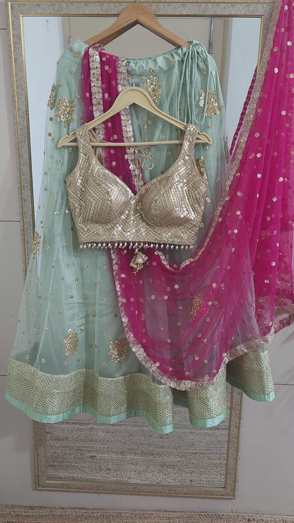 Pastel green lehenga choli with vibrant pink dupatta